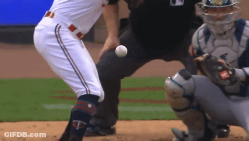 A Baseball Player With The Letter T On His Knee Is About To Throw The Ball GIF