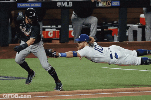 A Baseball Player With The Number 10 On His Jersey Sliding Into Base GIF