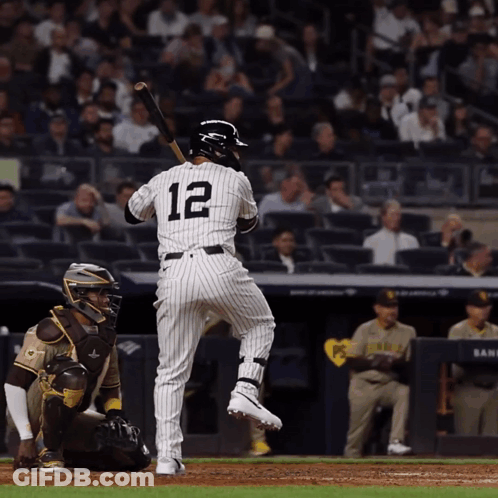 A Baseball Player With The Number 12 On His Back Is About To Swing His Bat GIF