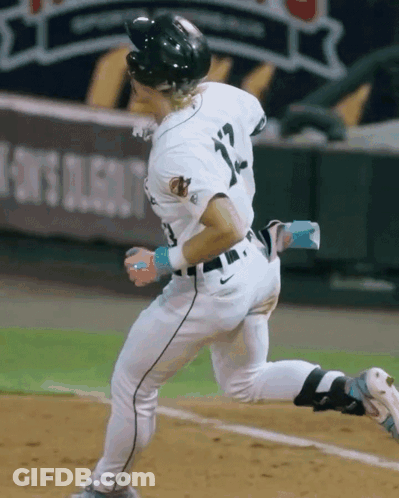 A Baseball Player With The Number 12 On His Jersey Is Running GIF