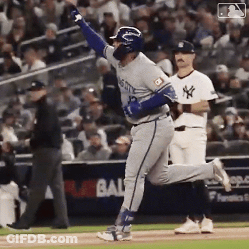 A Baseball Player With The Number 12 On His Jersey Is Running On The Field . GIF
