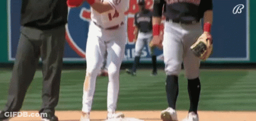 A Baseball Player With The Number 14 On His Jersey Is Standing On The Base . GIF