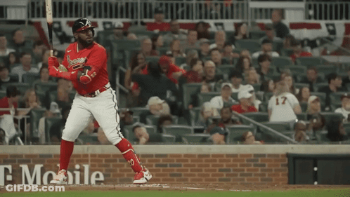 A Baseball Player With The Number 17 On His Jersey Is Swinging His Bat GIF