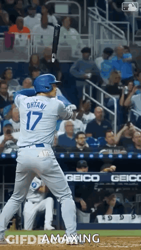 A Baseball Player With The Number 17 On His Jersey Is Swinging His Bat GIF