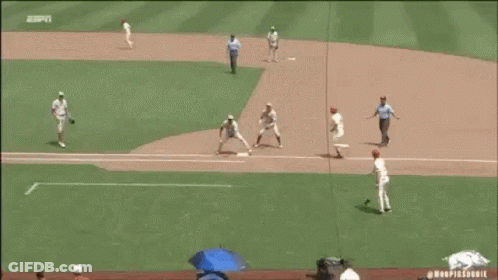 A Baseball Player With The Number 18 On His Jersey Talks To Another Player GIF