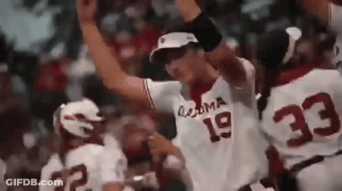 A Baseball Player With The Number 19 On His Jersey Is Standing In Front Of A Crowd . GIF