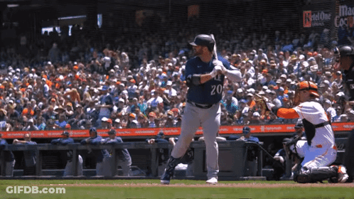 A Baseball Player With The Number 20 On His Jersey Swings His Bat GIF