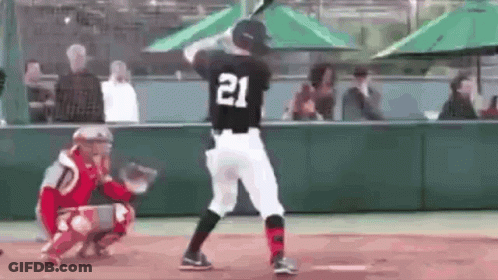 A Baseball Player With The Number 21 On His Back Is Swinging A Bat At A Ball . GIF