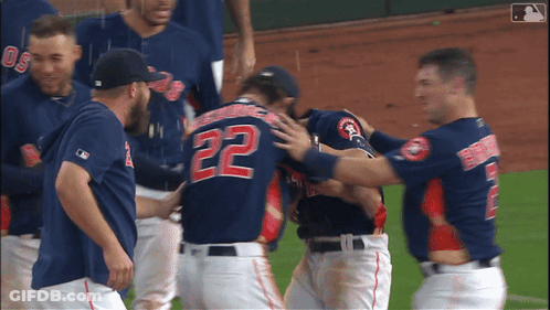 A Baseball Player With The Number 22 On His Back Is Hugged By His Teammates GIF