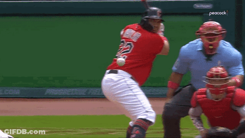A Baseball Player With The Number 22 On His Back Swings At A Ball GIF