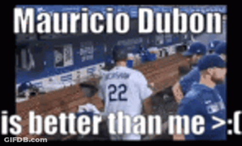 A Baseball Player With The Number 22 On His Jersey Is Standing In The Dugout . GIF