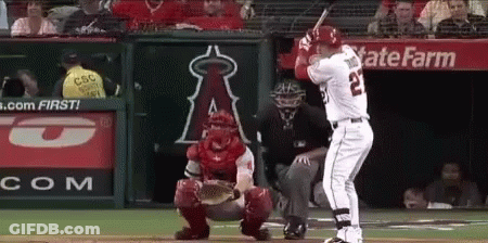 A Baseball Player With The Number 22 On His Jersey Is Swinging His Bat GIF