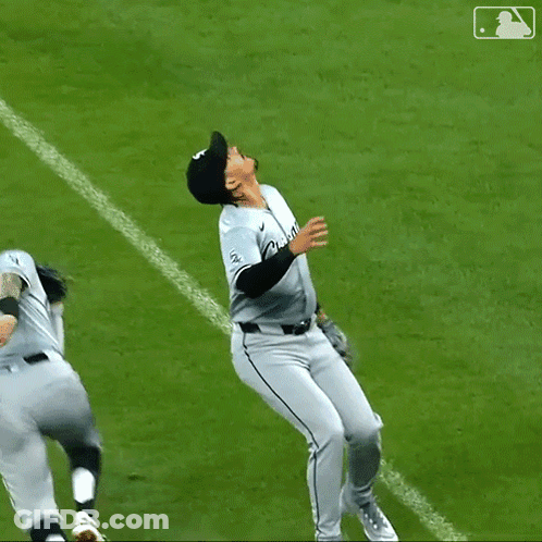A Baseball Player With The Number 23 On His Jersey Is Hugging Another Player GIF