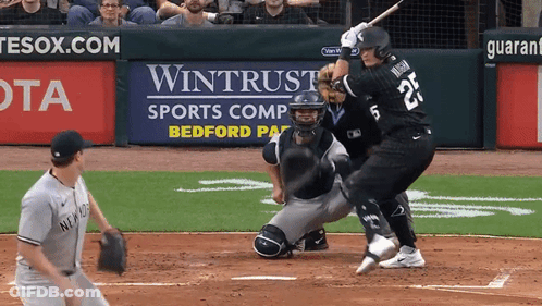 A Baseball Player With The Number 25 On The Back Of His Jersey Swings At A Pitch GIF