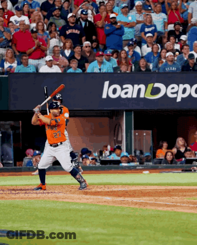 A Baseball Player With The Number 27 On His Jersey Is Swinging At A Pitch GIF