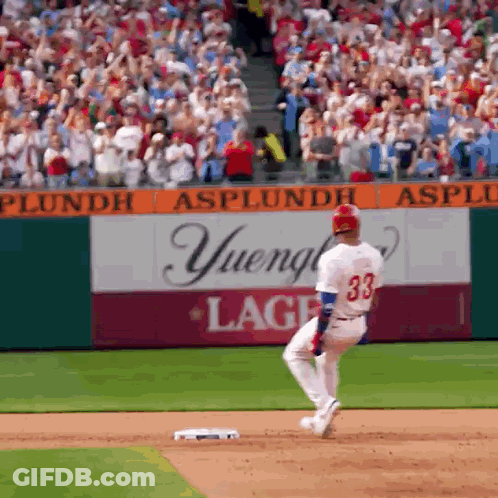 A Baseball Player With The Number 33 On His Jersey Is Running To Base GIF