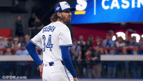 A Baseball Player With The Number 34 On His Jersey Stands On The Field GIF