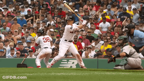 A Baseball Player With The Number 38 On His Back Is Swinging His Bat GIF