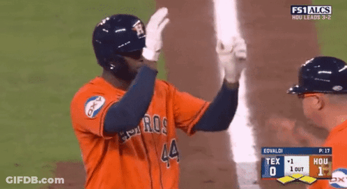 A Baseball Player With The Number 44 On His Jersey Is High Fiving Another Player GIF