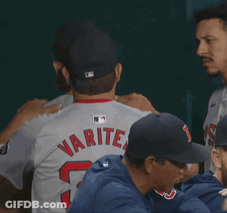 A Baseball Player With The Number 52 On His Jersey Is Hugging Another Player GIF