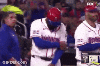 A Baseball Player With The Number 7 On His Helmet Is Being Hugged By Another Player GIF