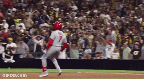 A Baseball Player With The Number 7 On His Jersey Is Running Towards The Base GIF