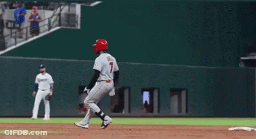 A Baseball Player With The Number 7 On His Jersey Is Standing On The Base GIF