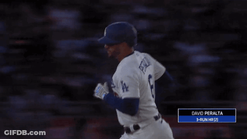 A Baseball Player With The Number 8 On His Jersey Reaches Up To Catch A Ball GIF