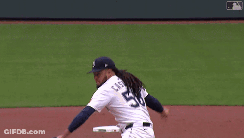 A Baseball Player With The Number 8 On The Back Of His Jersey Swings At A Pitch GIF