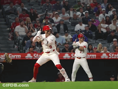 A Baseball Player With The Number 9 On His Jersey Swings His Bat GIF