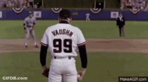 A Baseball Player With The Number 99 On His Back Is Standing On A Field . GIF
