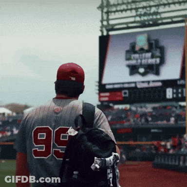 A Baseball Player With The Number 99 On His Back Walks On The Field GIF