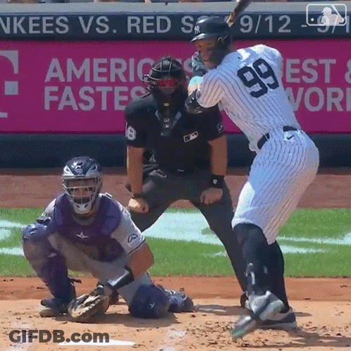 A Baseball Player With The Number 99 On His Jersey Is Swinging His Bat GIF