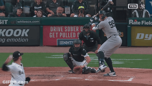 A Baseball Player With The Number 99 On His Jersey Swings At The Ball GIF