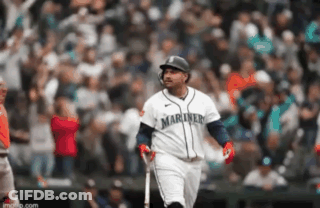 A Baseball Player With The Word Mariner On His Jersey Is Holding A Bat . GIF