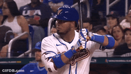 A Baseball Player With The Word Milwaukee On The Front Of His Jersey GIF