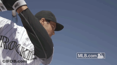 A Baseball Player With The Word Rockies On His Jersey Throws A Ball GIF