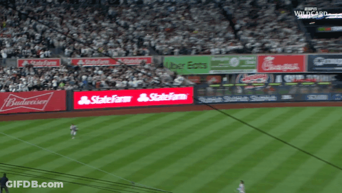 A Baseball Stadium With A Budweiser Ad On The Wall GIF