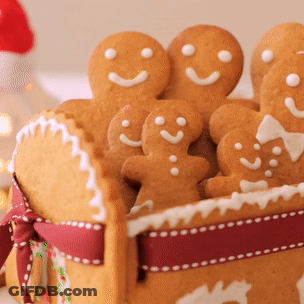 A Basket Filled With Gingerbread Men And Women With Smiley Faces On Them GIF