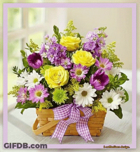 A Basket Filled With Yellow And Purple Flowers GIF