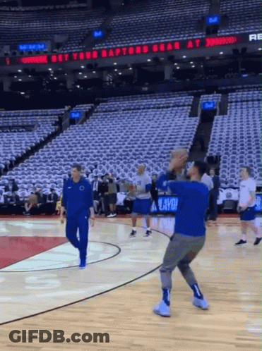 A Basketball Court With A Sign That Says " Get Your Raptors Bear At " GIF