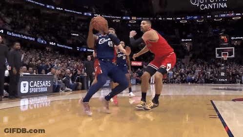 A Basketball Game Being Played In Front Of A Caesars Sportsbook Banner GIF