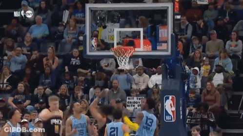 A Basketball Game Being Played In Front Of A Crowd With A Sign That Says Hit The Crispy GIF