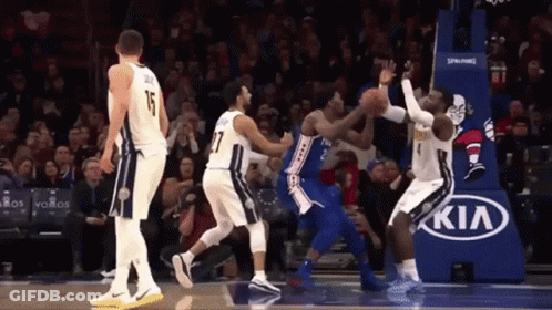 A Basketball Game Being Played In Front Of A Kia Advertisement GIF