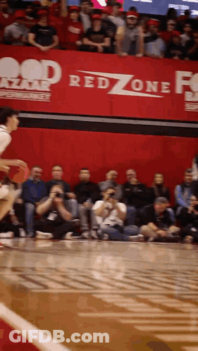 A Basketball Game Being Played In Front Of A Red Zone Sign GIF
