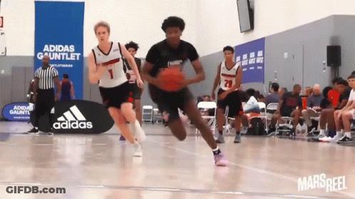 A Basketball Game Being Played In Front Of An Adidas Sign GIF