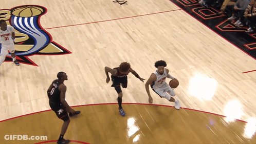 A Basketball Game Being Played On A Court With A Pistons Logo On The Floor GIF