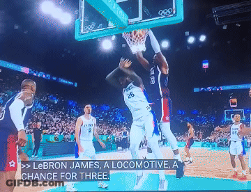 A Basketball Game Is Being Played And Lebron James Is Dunking GIF