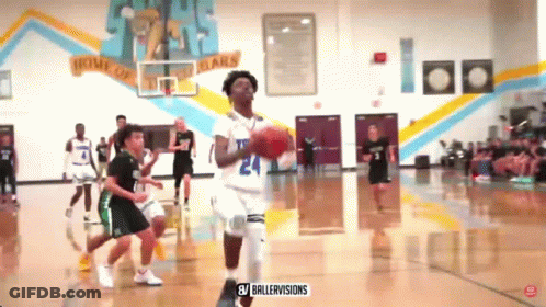 A Basketball Game Is Being Played In A Gym With A Banner On The Wall That Says Home Of The Bears GIF