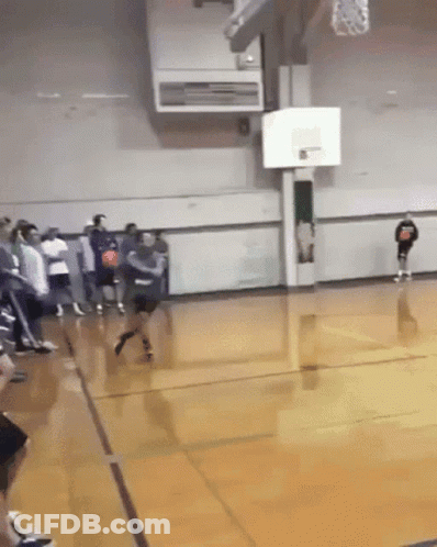 A Basketball Game Is Being Played In A Gym With A Player Wearing A Shirt That Says ' Basketball ' GIF